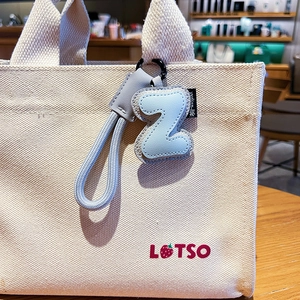 Creative letter Z leather keychain with stitching details on a stylish canvas bag