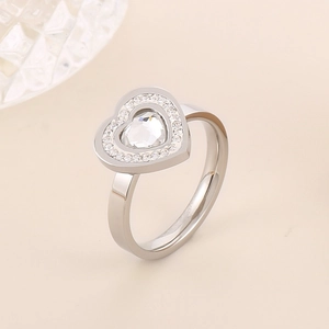 Macro shot of silver heart ring with micro-paved crystals on polished stainless steel