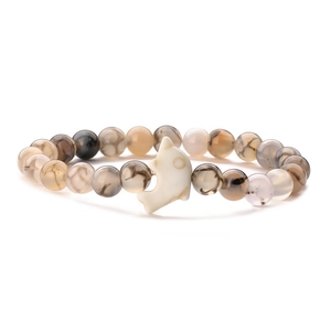 Close-up of beaded dolphin bracelet with tiger eye stone and natural agate textures