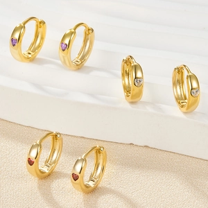 Three pairs of heart-shaped crystal earrings in purple, white, and red on gold settings