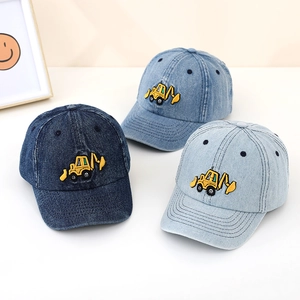 Detailed view of kids denim baseball caps with yellow excavator embroidery in three blue shades