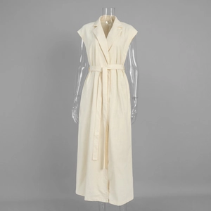 Detail of cream sleeveless shirt dress showing waist tie and lapel collar texture