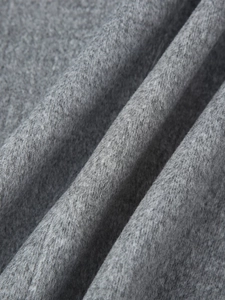 Detailed macro shot showing the soft texture and fibers of the grey wool blend fabric