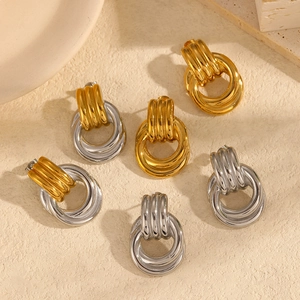 Two-tone gold and silver link hoop earrings in minimalist geometric knot design