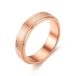 Rose gold spinner ring with colorful frosted finish and polished inner steel band