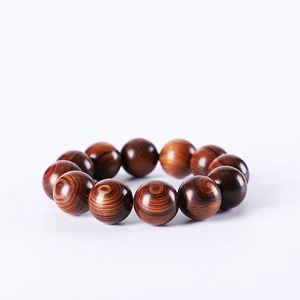 Polished Argentine Green Sandalwood beads bracelet with natural wood grain on white background