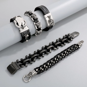 Detailed set of five punk men's leather bracelets with skull and tiger head metal motifs