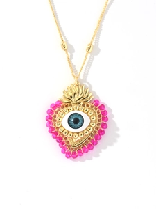 Detail of 18k gold heart pendant with blue evil eye and pink beads on a chain