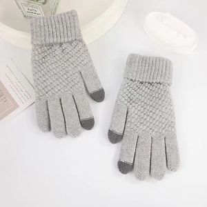 Close-up of grey knit touchscreen gloves showing conductive yarn tips for smartphone use