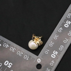 Elegant white freshwater pearl stud earrings with gold micro-paved zircon flower accents