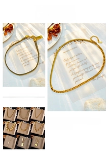 Detail view of various gold-plated chain necklaces with heart, star, and pearl pendants