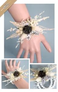 Detail of forest style wrist corsage with dried pine cones, flowers and pearl beads