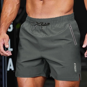 Detail of dark grey quick-dry sports shorts with elastic waist, drawstring and logo