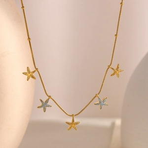 Detail of 18K gold-plated stainless steel necklace with textured starfish charms
