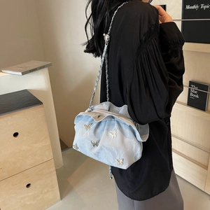 Chic light blue pleated cloud bucket bag with silver butterfly and chain strap