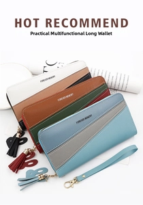 Detail of color-block long wallets with zipper closure, tassel pendant and wrist strap
