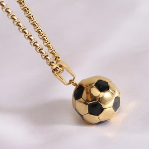 Close-up of a 3D gold football pendant necklace with black enamel soccer details