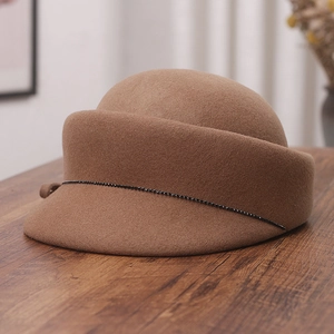Detail of camel wool felt equestrian hat featuring a delicate black beaded chain trim