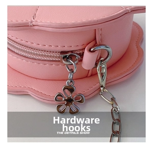 Detail of pink flower bag featuring silver hardware hook and smooth zipper puller