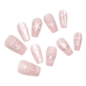 Pink cat eye press-on nails set with 3D bows, glitter stars, and pearls on white background
