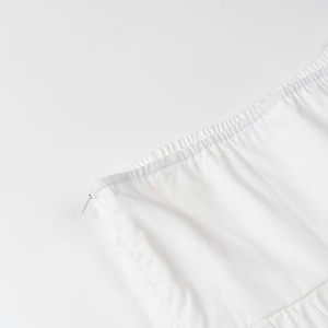 Detail shot of the invisible zipper and elastic side seam on this white crop top