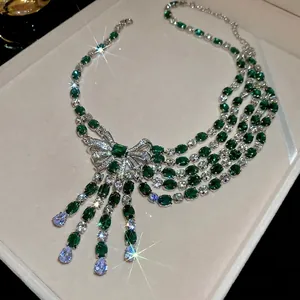 Bowknot emerald tassel necklace with zircon stones in luxury banquet style display
