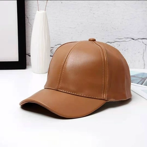 Detailed view of the dark brown PU leather texture on a classic baseball cap