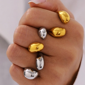 Minimalist gold and silver water drop rings with PVD 18K plating on a hand