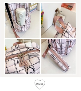 Detail view of pink plaid backpack featuring side pocket, reinforced handle and pouch
