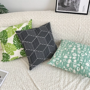 Detailed view of fresh green leaf and geometric patterns on cotton linen cushion covers