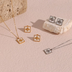 Elegant gold and silver bee pendant necklace with matching square shell earrings