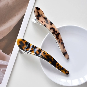 Detail view of large acetate claw clips with classic leopard and tortoiseshell patterns