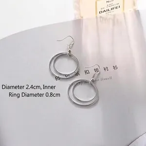 Minimalist silver double layered hoop earrings featuring glossy metallic dual rings