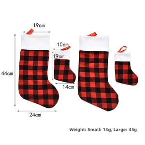 Size comparison of large and small red buffalo plaid Christmas stockings with white plush trim