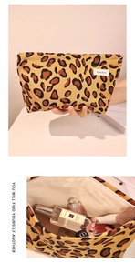 Detailed interior of the leopard print corduroy makeup bag with cosmetics and label
