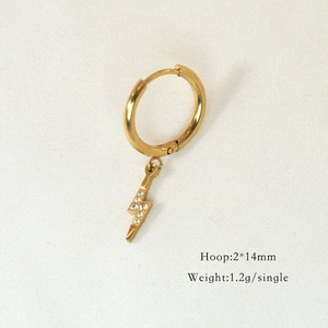 Detailed close-up of a gold lightning bolt hoop earring with white cubic zirconia stones