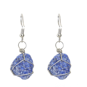Detail of handmade wire-wrapped silver earrings with natural blue lapis lazuli stones