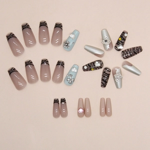 Long trapezoid press-on nails with zebra pattern, silver mirror, and gothic cross design