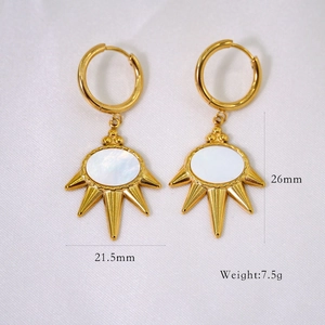 Detail showing 21.5mm x 26mm gold earrings with starburst mother of pearl pendants
