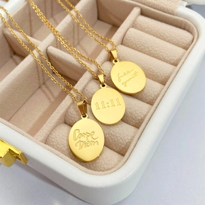 Gold oval titanium steel pendants with Carpe Diem, 11:11, and Free Spirit engraving