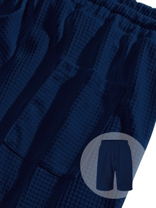 Detailed macro view of men's dark blue waffle knit shorts with elastic drawstring waist