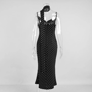 Detail view of the back halter tie design on a black polka dot long fishtail dress
