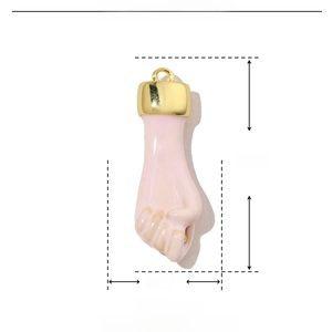 Macro view of a pink fist charm made of copper and enamel showing 26mm x 9mm dimensions