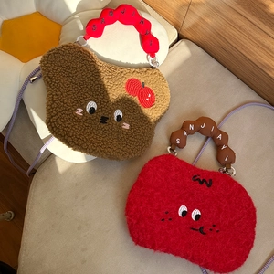 Detail of plush cartoon bags with fine embroidery and textured lamb wool fabric