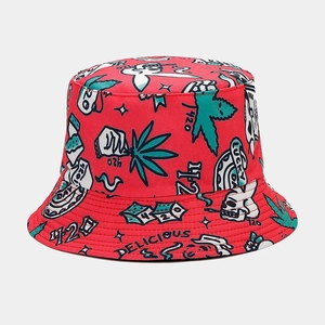 Macro detail of red reversible bucket hat with all-over cannabis leaf and cartoon print