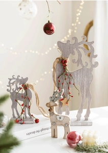 Detailed view of three-piece wooden Christmas reindeer set with twine and red berries