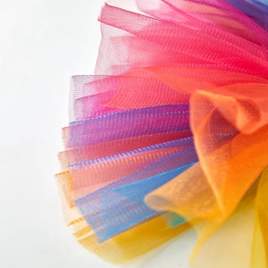 Macro shot of colorful layered rainbow tulle fabric for pet tutu skirts with soft texture