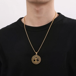 Close-up of golden Tree of Life pendant with Celtic knot edge on a male model