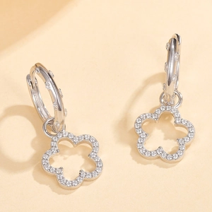 Detailed macro view of S925 silver flower earrings with micro-set cubic zirconia stones