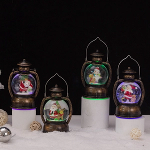 Detail of vintage bronze Christmas lanterns with glowing LED lights and festive figurines